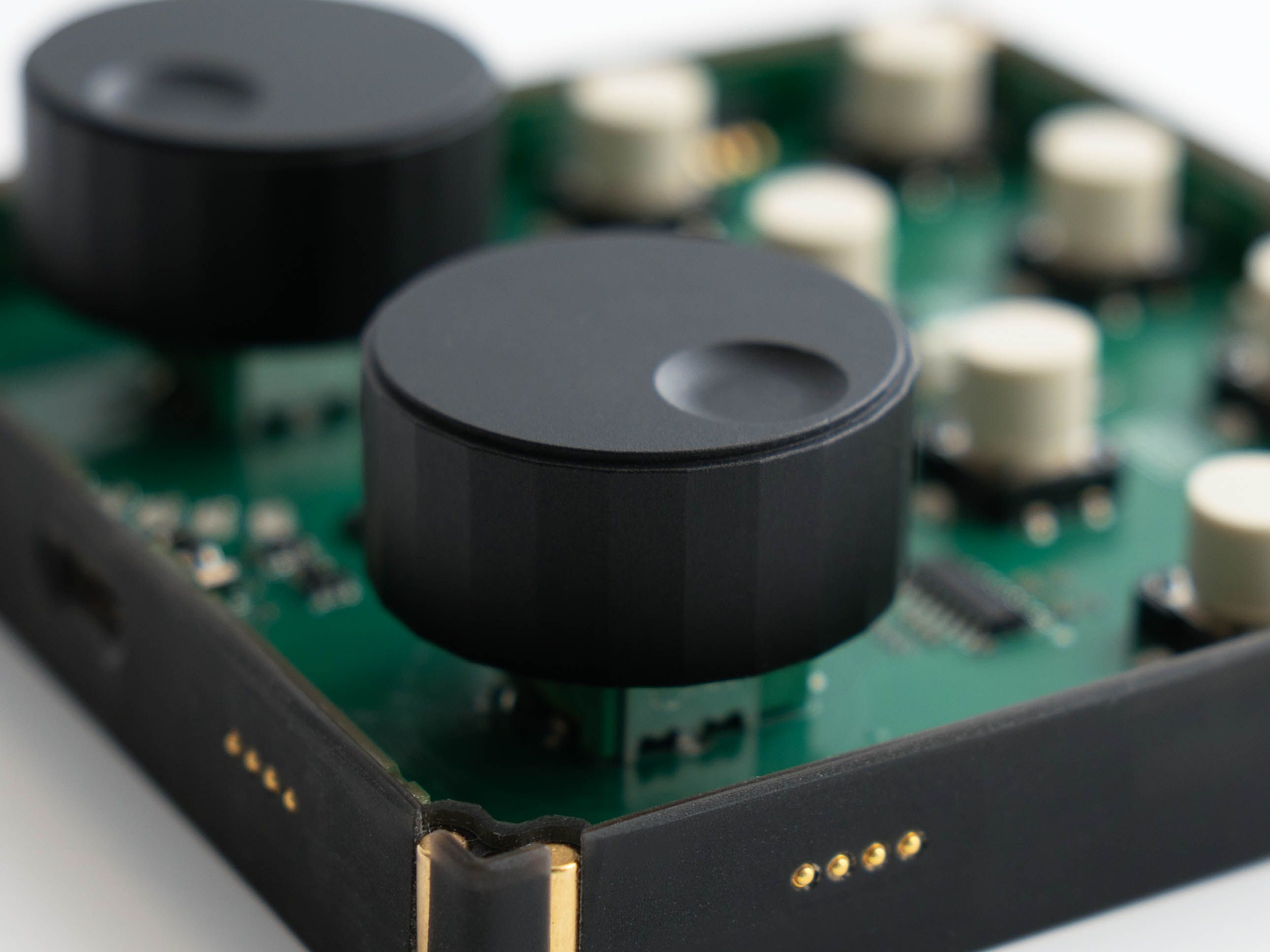  Printed circuit with knobs and buttons in the background