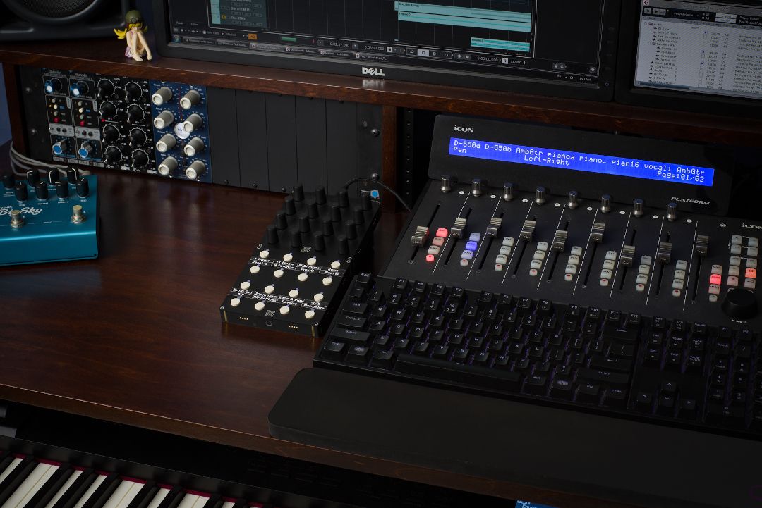 Studio gear and grid controllers on a dark desk